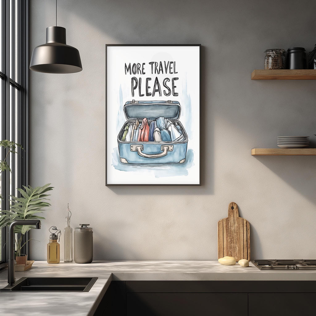a framed poster with the text "MORE TRAVEL PLEASE" hanging on a wall above a kitchen counter.