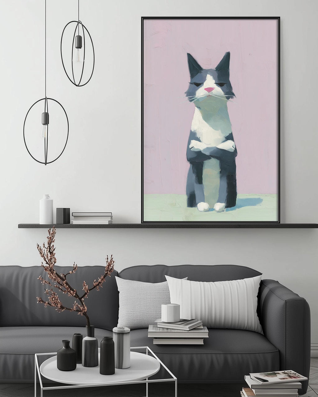 a gray couch with a white pillow, a coffee table with various decorative items, and a large framed painting of a cat on the wall above the couch.