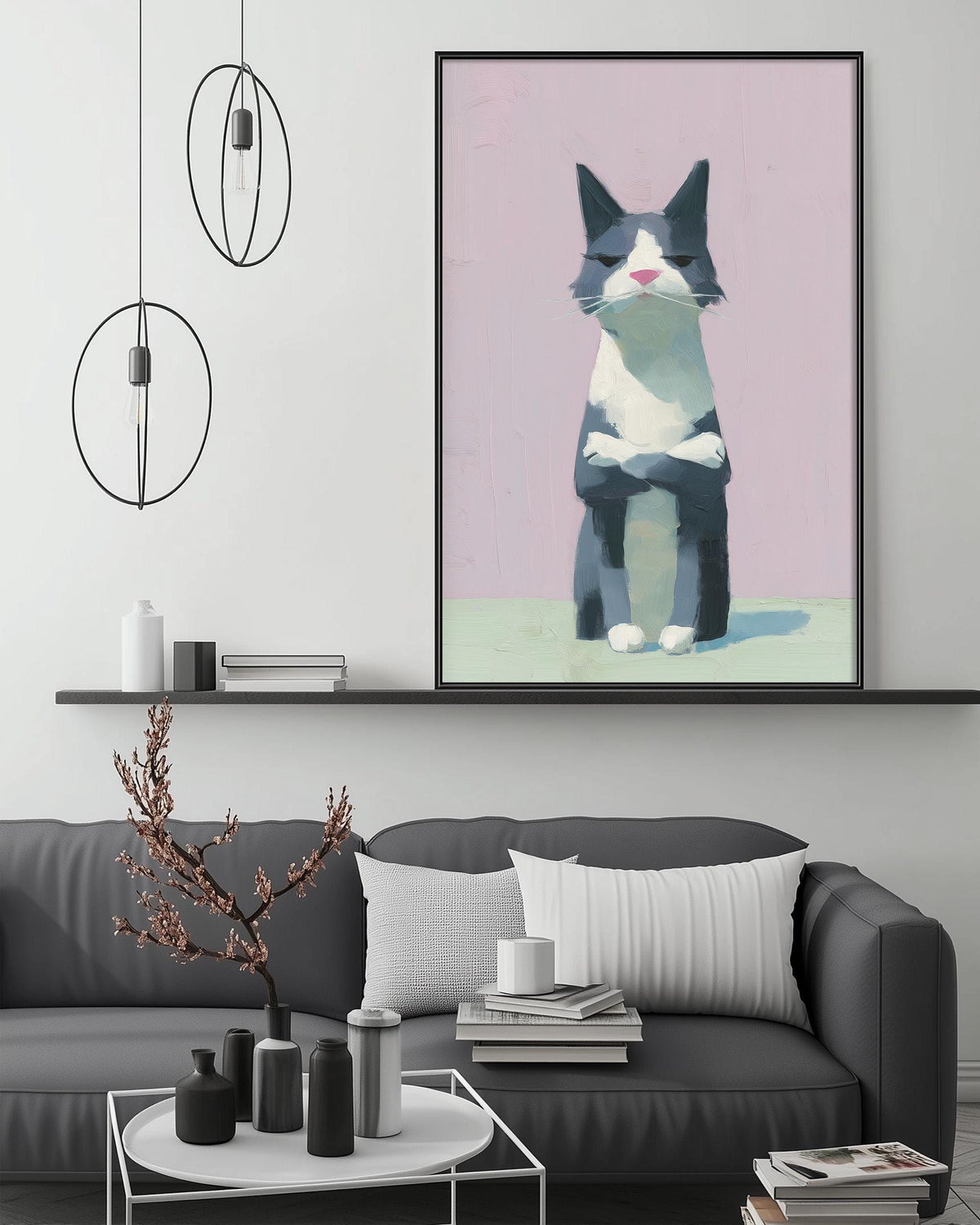 a gray couch with a white pillow, a coffee table with various decorative items, and a large framed painting of a cat on the wall above the couch.