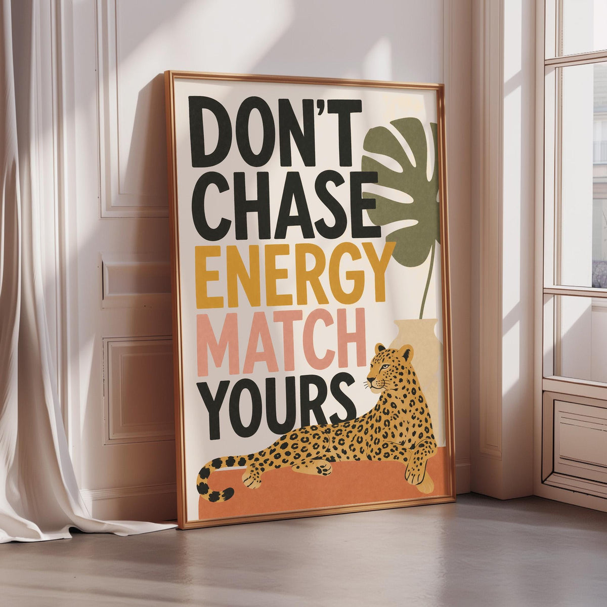 a poster with a leopard and the text "DON'T CHASE ENERGY MATCH YOURS" displayed on a wall.