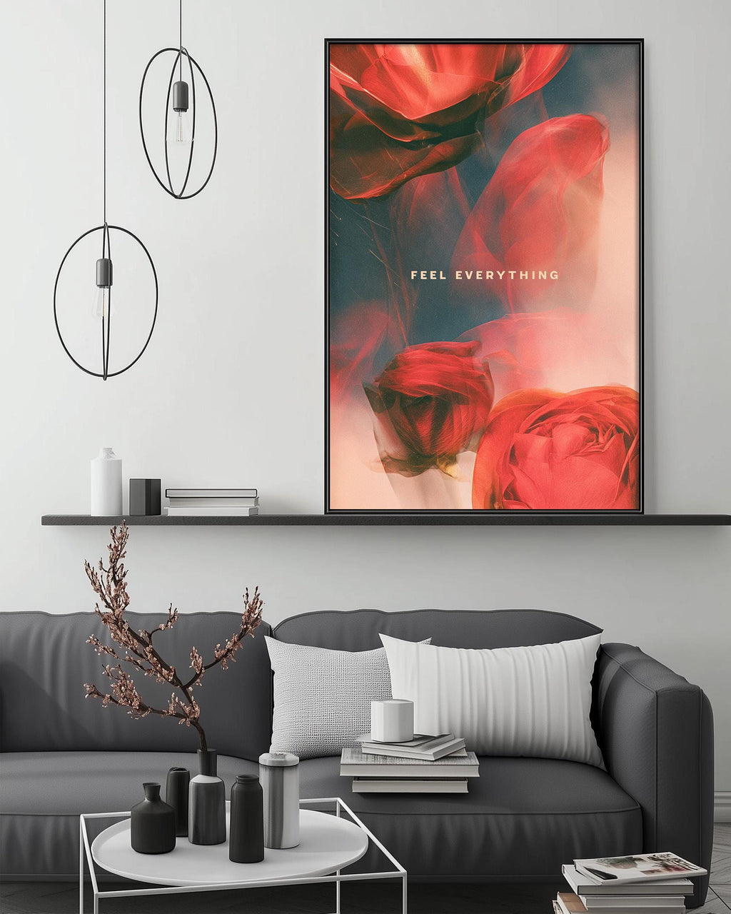 a modern living room with a gray sofa, a coffee table, and a large framed poster of red roses hanging on the wall.