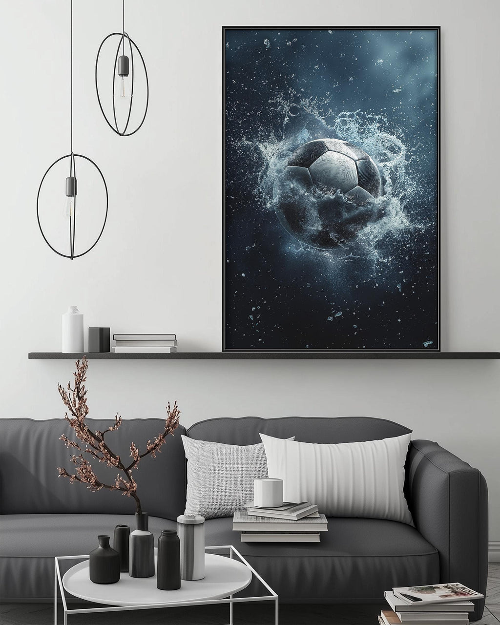 a modern living room with a gray sofa, a coffee table, and a large framed artwork depicting a soccer ball surrounded by water splashes.