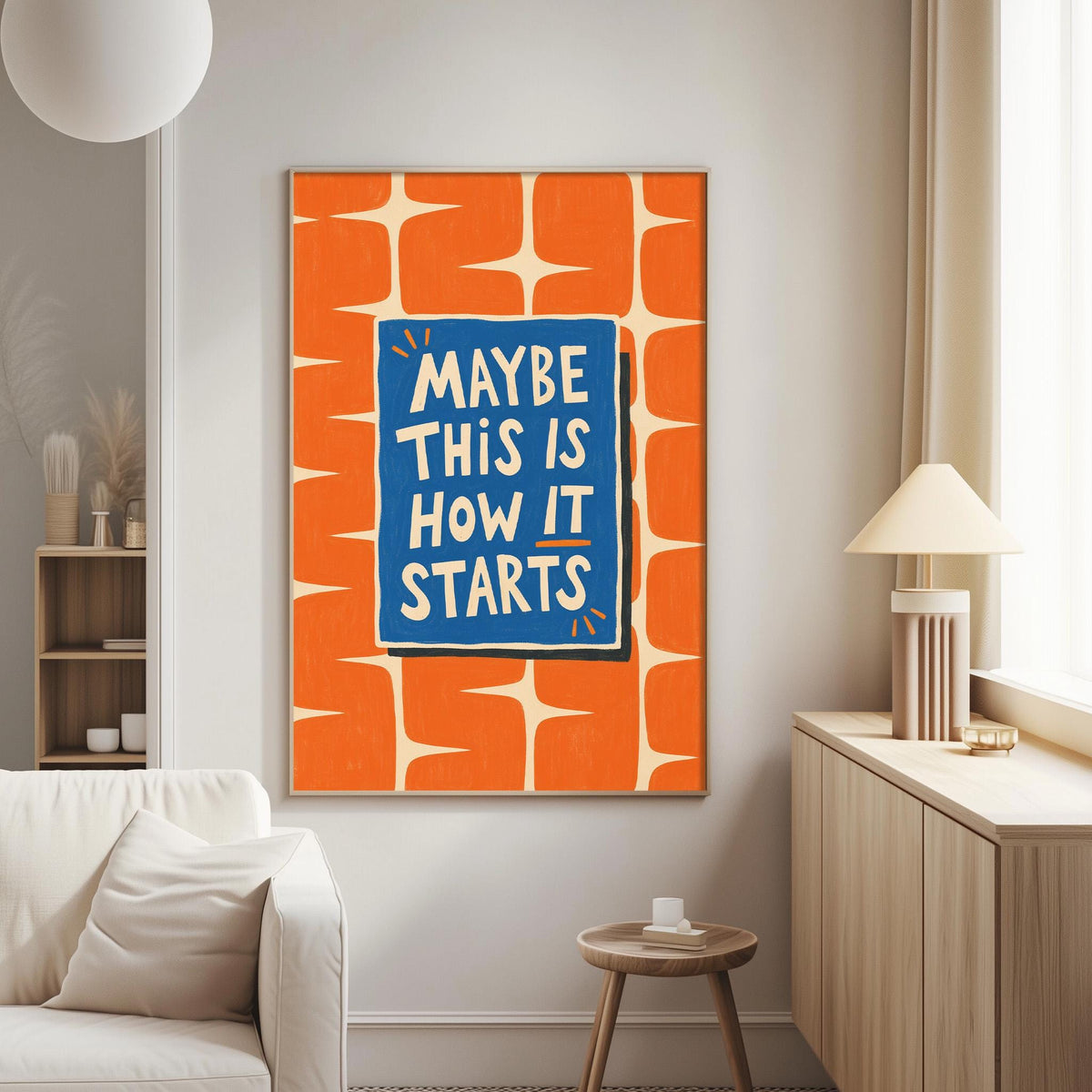 a living room with a large orange and blue poster on the wall that says "MAYBE THIS IS HOW IT STARTS".