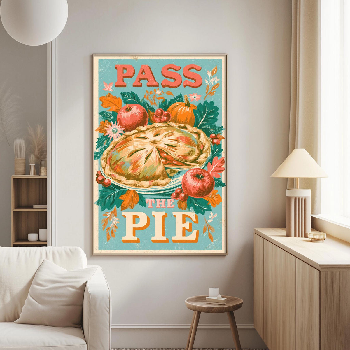 a large framed poster with a colorful illustration of a pie surrounded by autumn leaves and flowers, along with the text "PASS THE PIE" displayed prominently.
