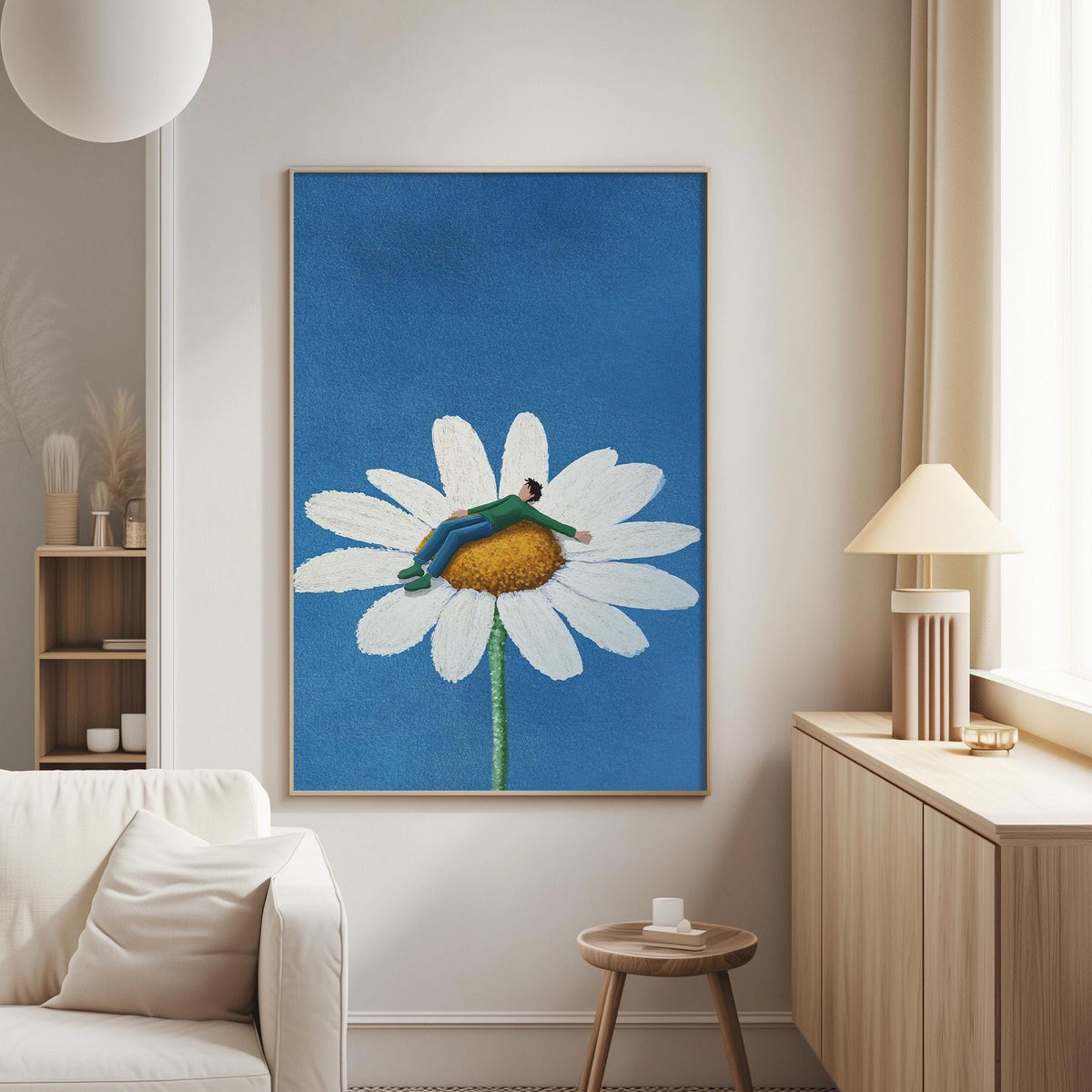 a large painting of a person lying on a white flower against a blue background, hanging on a wall in a living room.