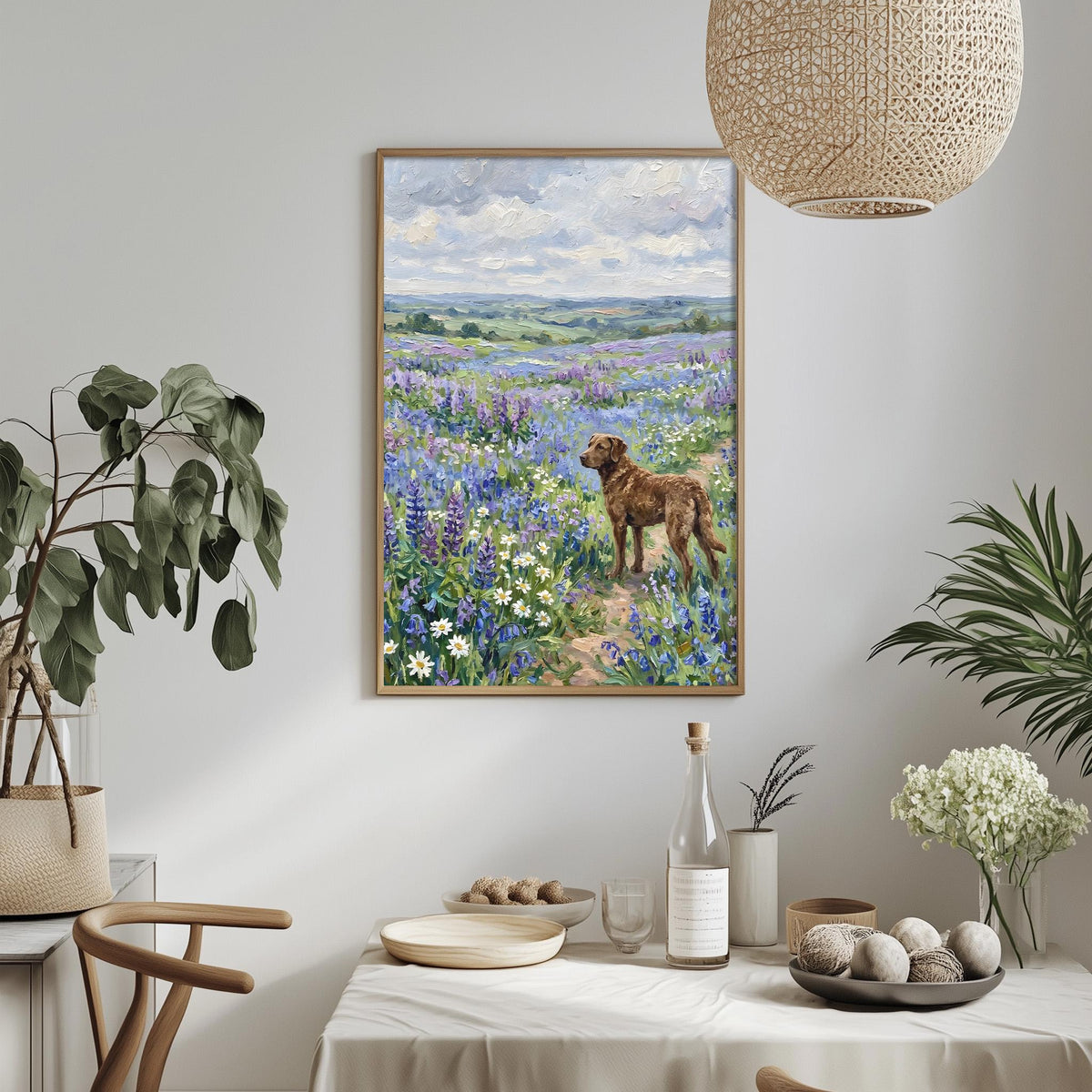 a painting of a dog standing in a field of flowers, with a table set with plates, bowls, and a bottle of wine in the foreground.