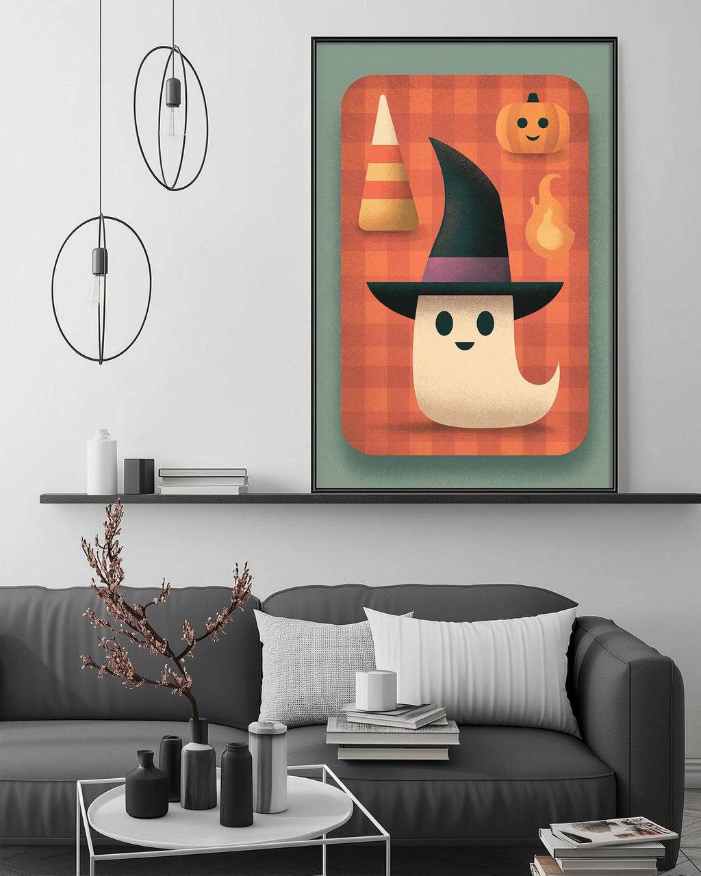 a cozy living room with a gray couch, a coffee table, and a framed Halloween-themed artwork hanging on the wall above the couch.