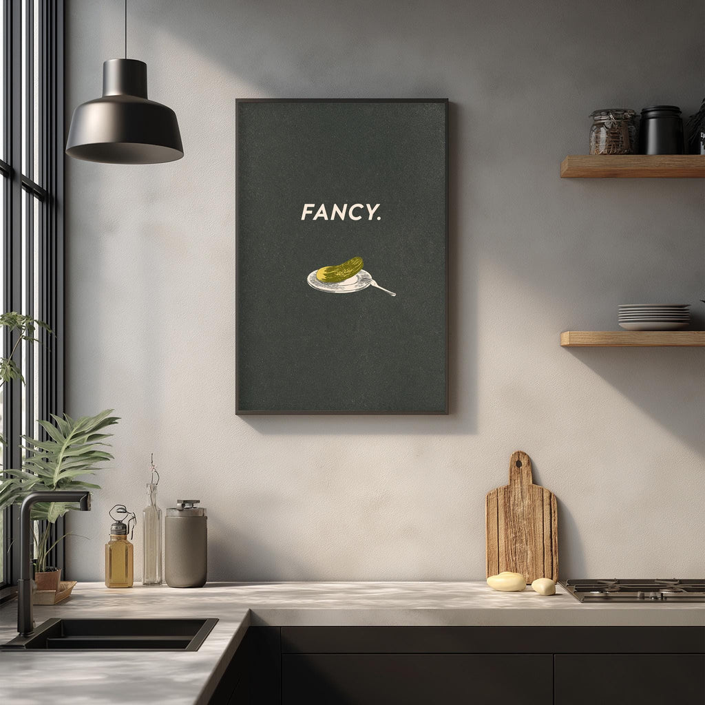 a kitchen counter with various kitchen items, including a cutting board, a bottle, and a plant. Above the counter, there is a framed poster with the word "FANCY" written on it.