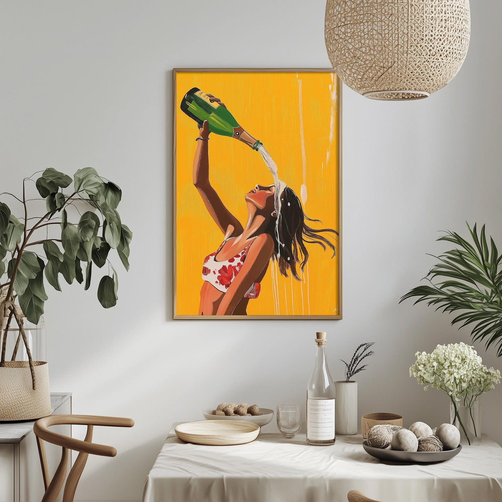 a framed painting of a woman in a red and white top pouring champagne from a green bottle, with a yellow background. The painting is hung on a white wall above a dining table with various decorative items, including potted plants, vases, and bowls.