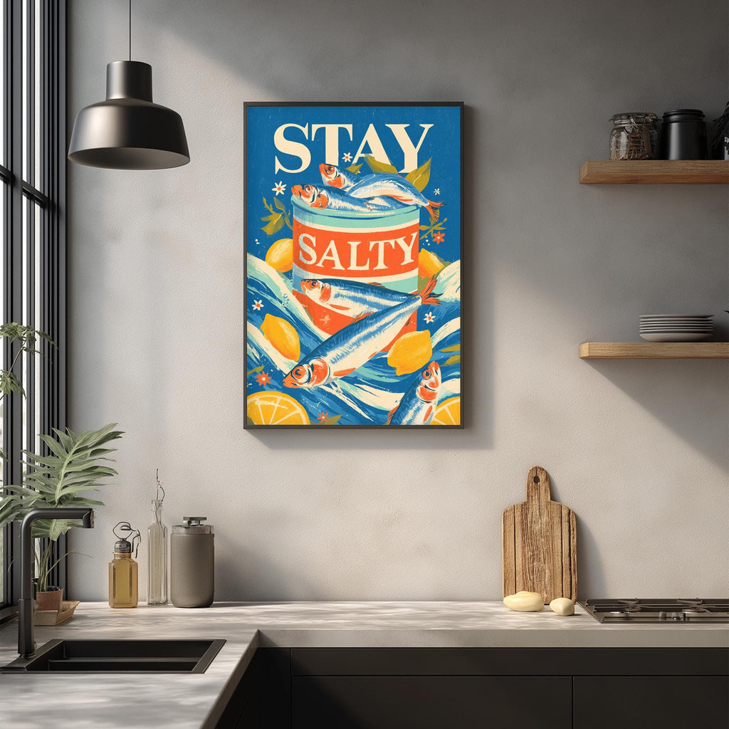 a kitchen counter with various kitchen items, such as a cutting board, a bottle, and a bowl. Above the counter, there is a framed poster with the text "STAY SALTY" and illustrations of fish and lemons.