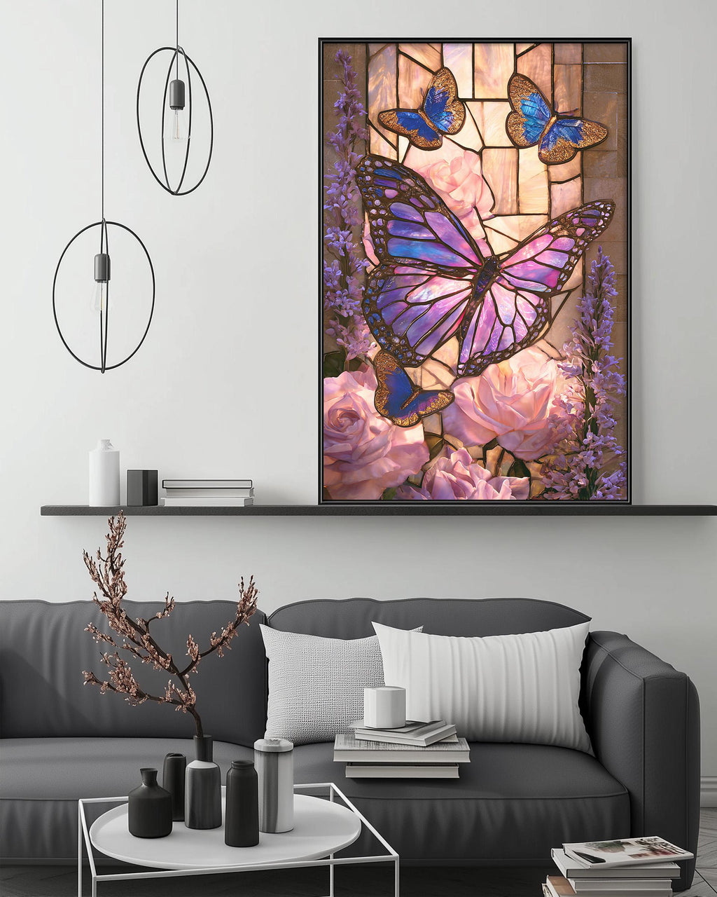 a large framed painting of a butterfly and flowers hanging on a wall above a gray couch in a living room setting.