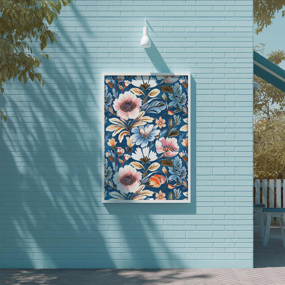 a blue wall with a framed floral print hanging on it. The wall is situated next to a wooden deck and a tree, creating a serene and inviting outdoor setting.