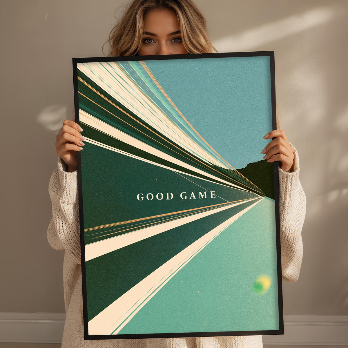 A woman holding a framed poster with the text "GOOD GAME" on it.