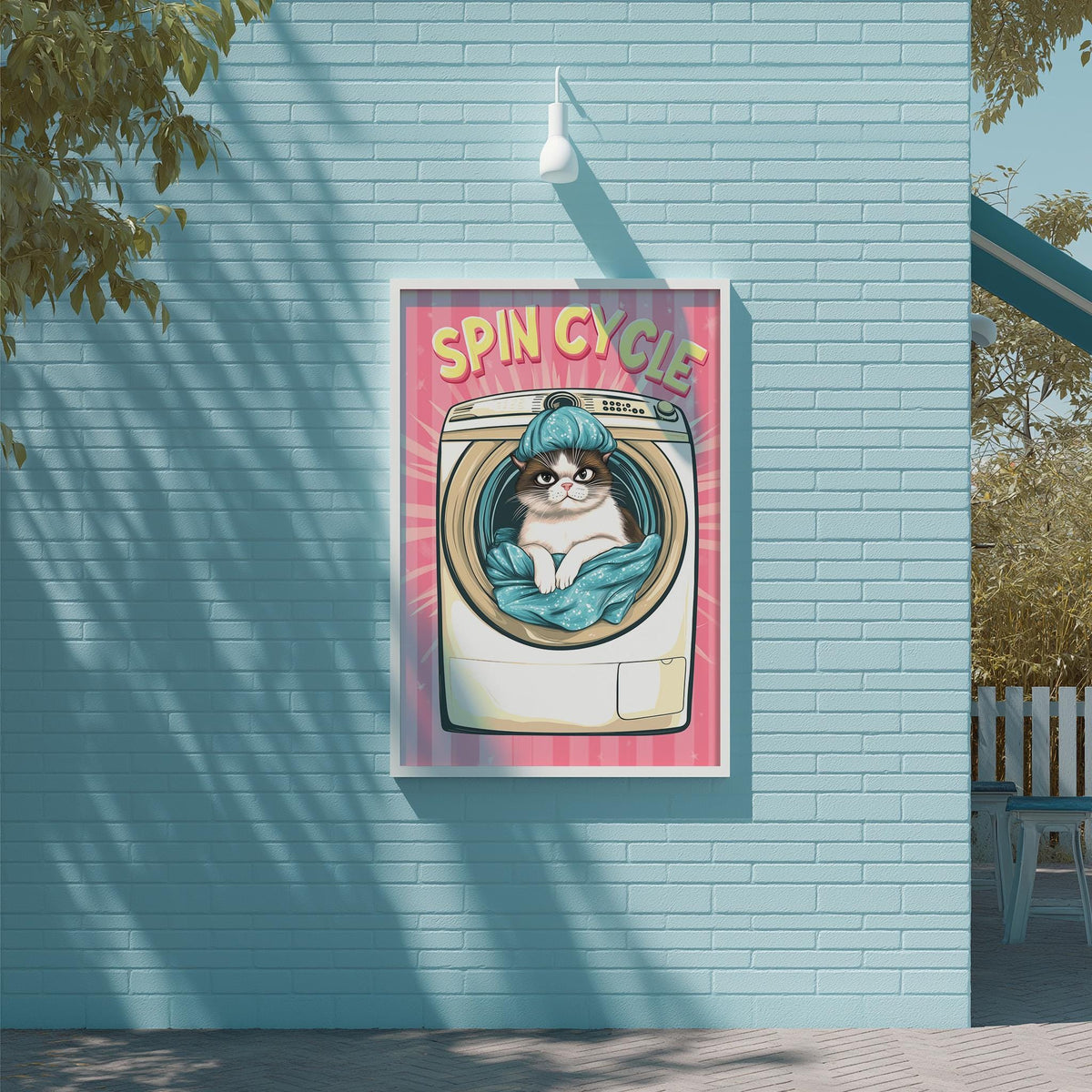a poster with a cat sitting inside a washing machine, surrounded by a pink and yellow background.