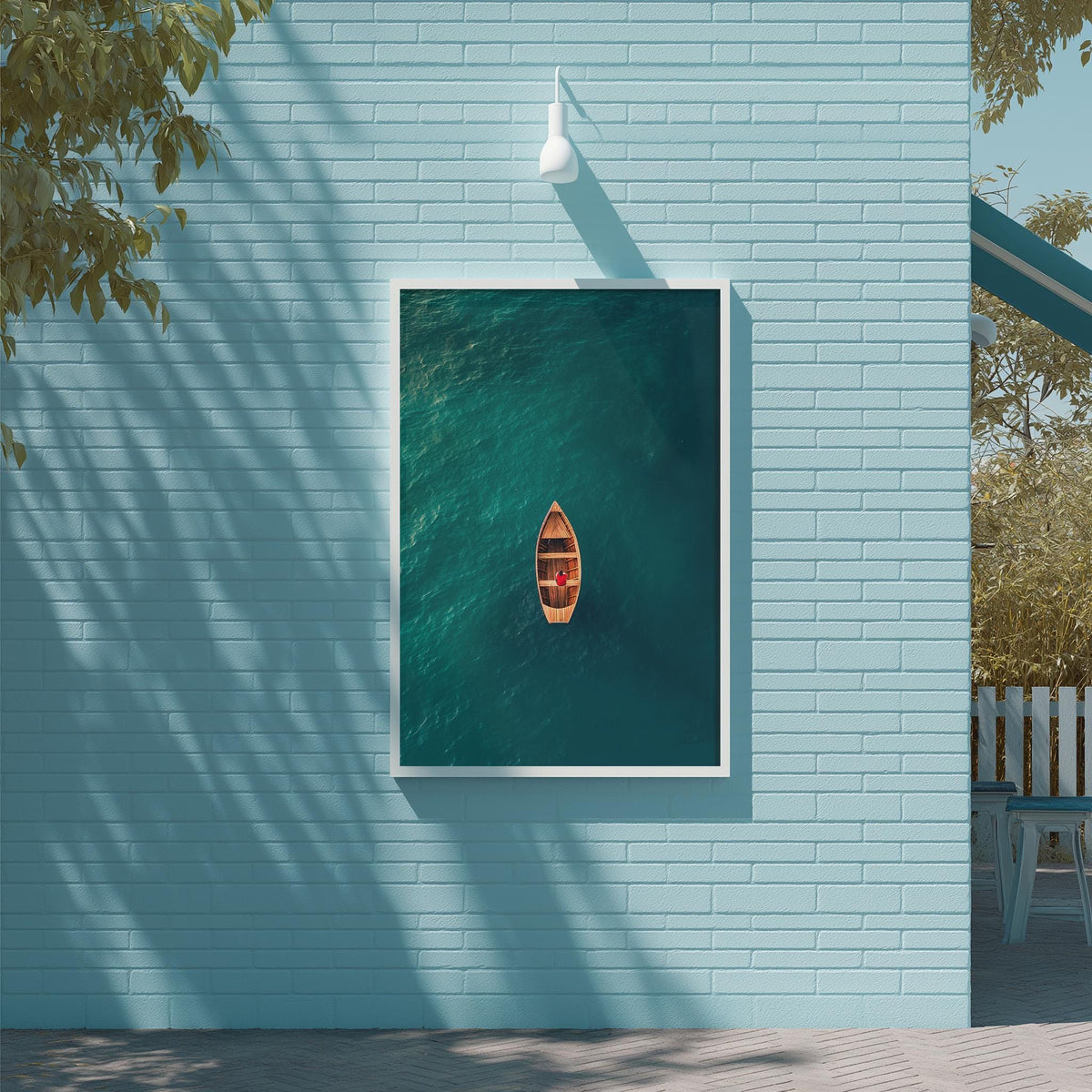 A small orange boat is floating on a calm, turquoise body of water, framed by a light blue wall and a white light fixture.