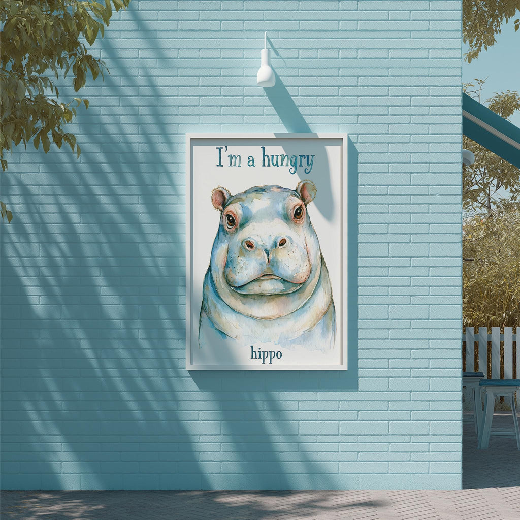 A framed illustration of a hippopotamus with the text "I'm a hungry hippo" is displayed on a light blue brick wall.