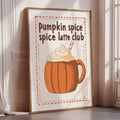 A framed poster advertising a pumpkin spice latte club, featuring an illustration of a pumpkin spice latte with whipped cream and a straw.
