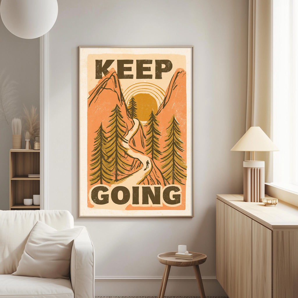 a poster with the text "KEEP GOING" displayed prominently on it, which is hanging on a wall in a living room setting.