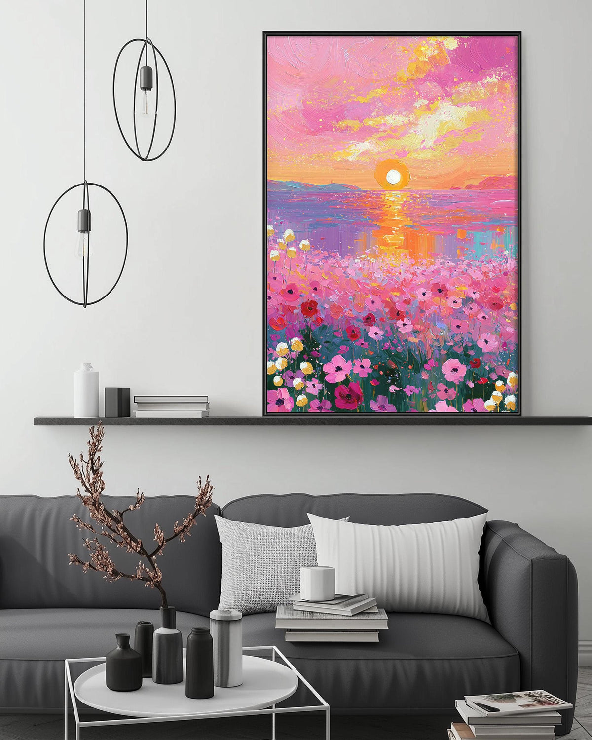 a large, vibrant painting of a field of flowers with a sunset in the background, hanging on a wall above a gray couch with a coffee table in front of it.