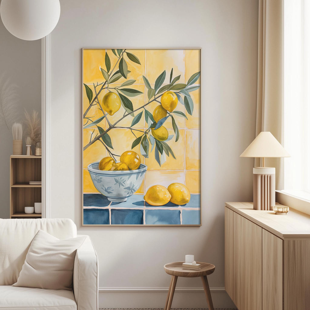 a living room with a large painting of a bowl of lemons hanging on the wall. The painting is surrounded by a white couch and a wooden side table.