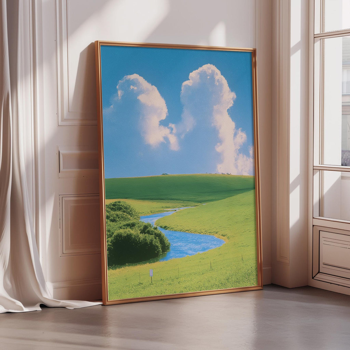 a large framed picture of a serene landscape with a winding river, lush green fields, and a blue sky with fluffy white clouds.