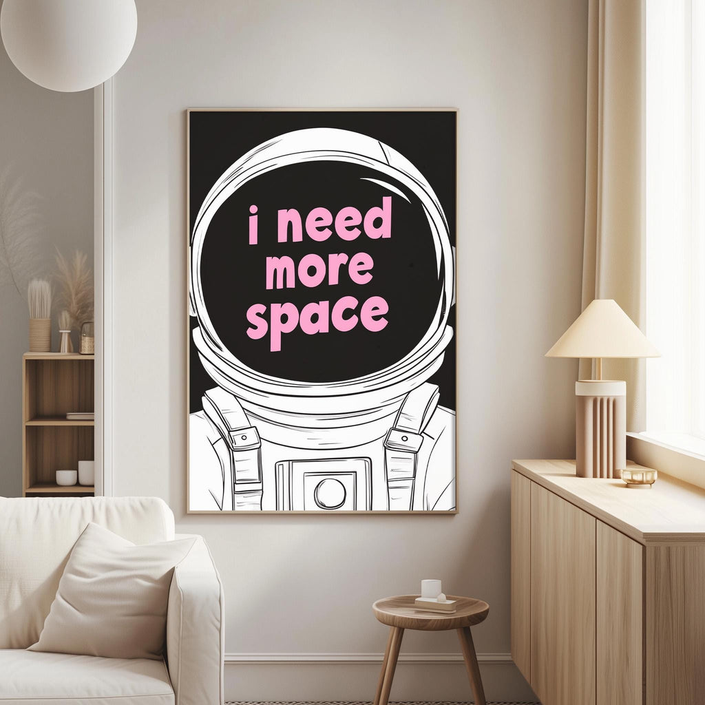 a poster with the text "I need more space" in pink and black, depicting an astronaut's helmet.