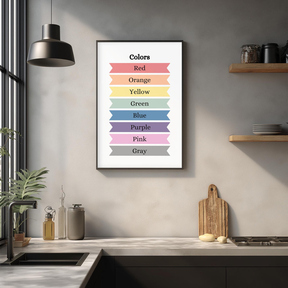 a kitchen counter with various items on it, such as a cutting board, a soap dispenser, and a bottle. Above the counter, there is a framed poster or artwork that displays a color-coded list of colors, including red, orange, yellow, green, blue, purple, pink, and gray.