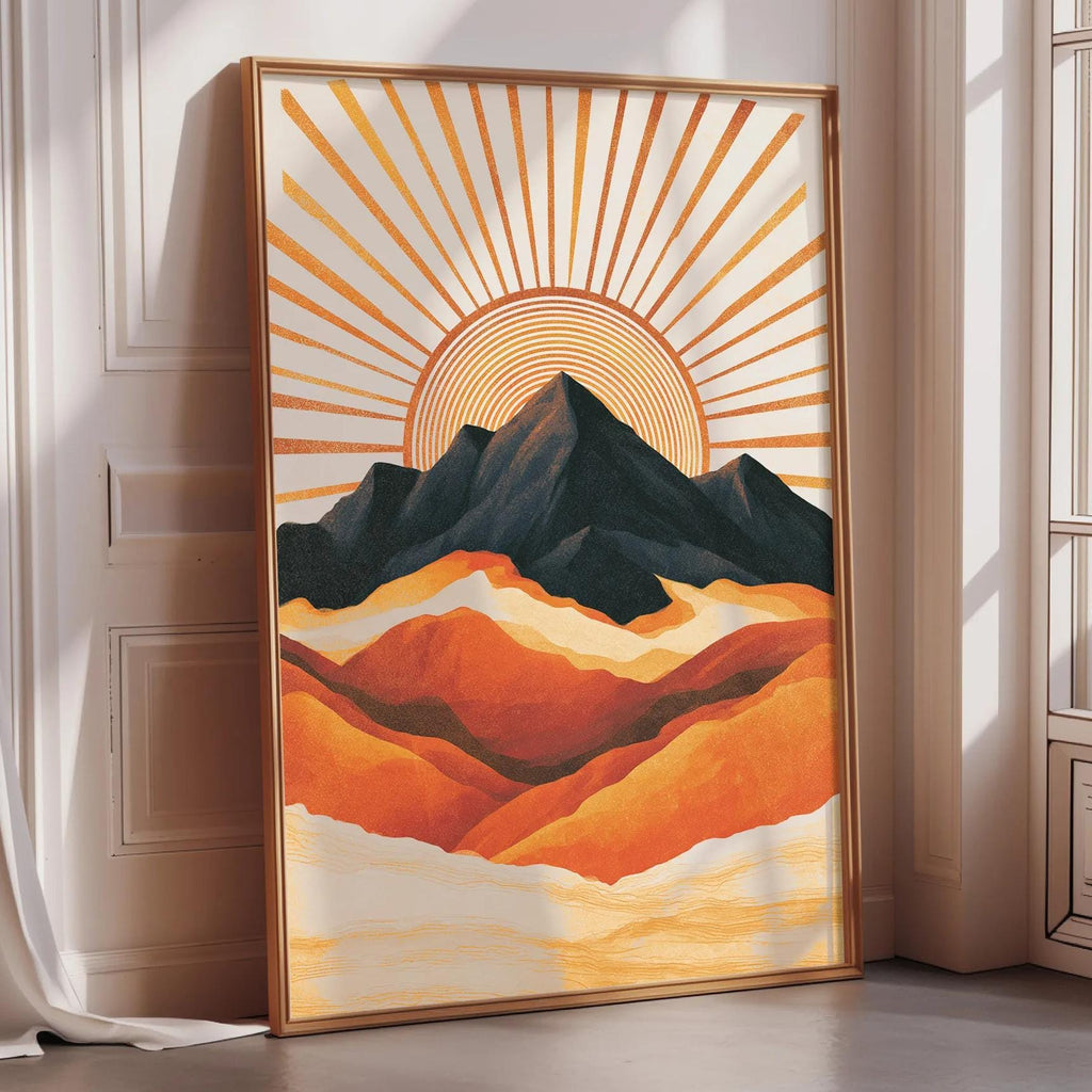 A framed painting depicting a mountain landscape with a sunburst design in the background.
