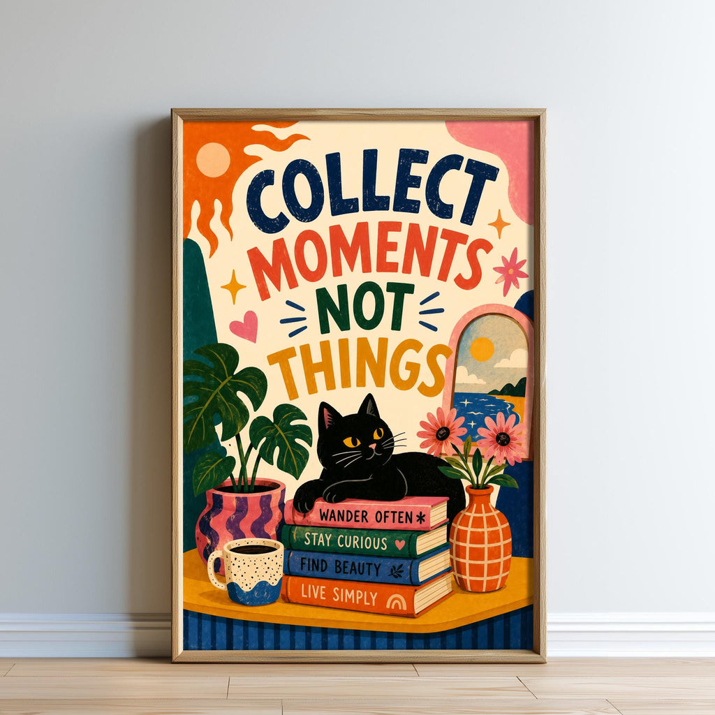 The image is a framed poster with a colorful and whimsical design. It features a cat sitting on a stack of books, surrounded by various objects such as a vase, a plant, and a cup. The poster has a motivational message that reads "Collect moments, not things" and includes the words "wander often", "stay curious", "find beauty", and "live simply".