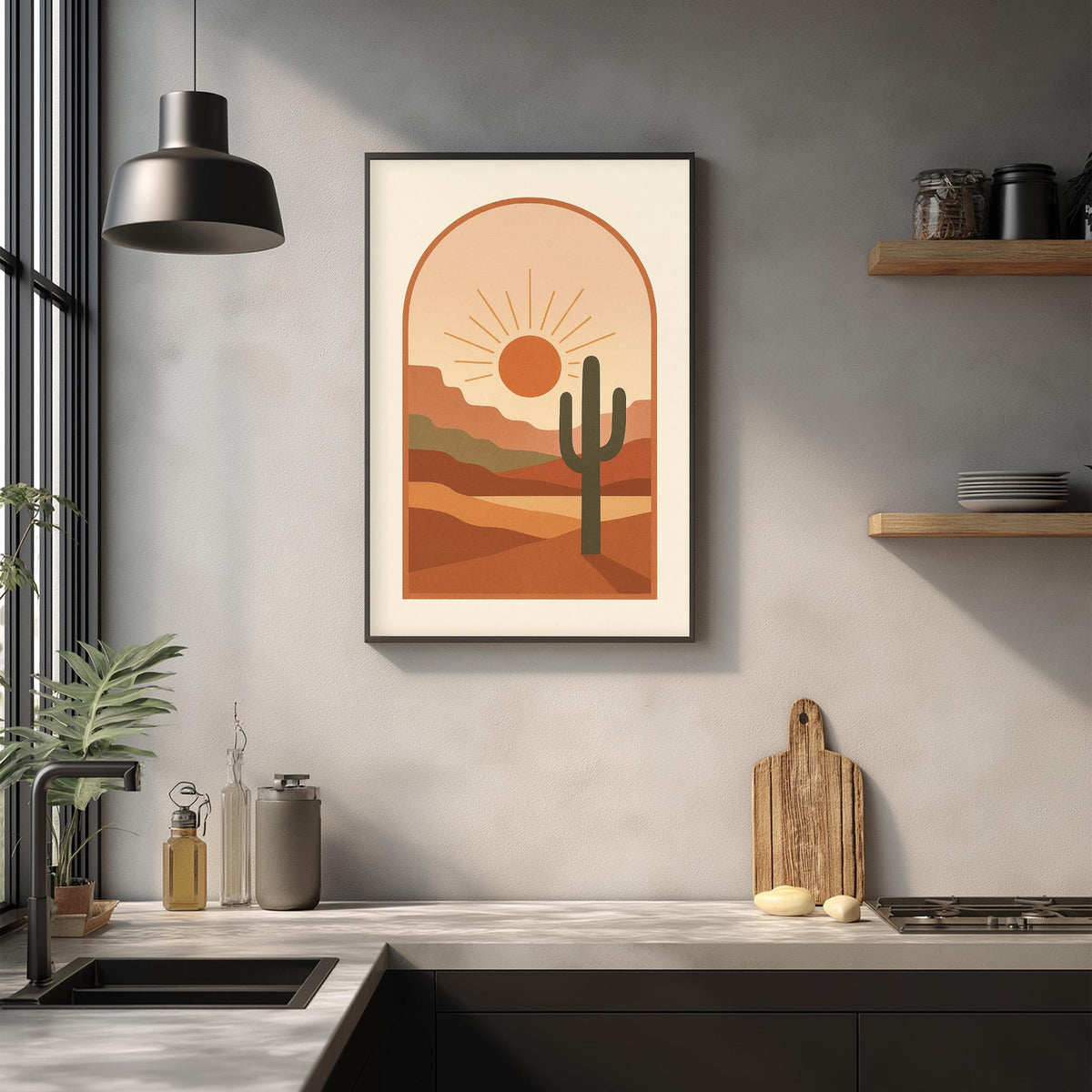a framed desert landscape artwork hanging on a wall above a kitchen counter with various kitchen items and decor.