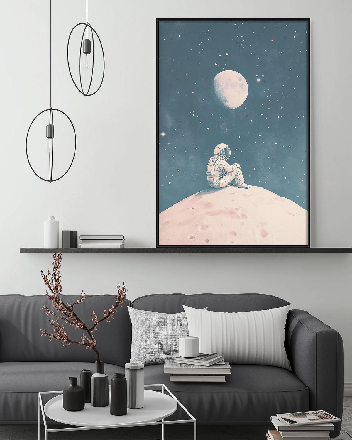 a cozy living room with a gray sofa, a coffee table, and a large framed artwork depicting an astronaut sitting on a rocky surface, gazing up at the moon and stars.