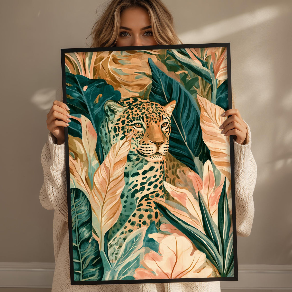 A woman holds up a framed print of a leopard surrounded by tropical foliage, including palm leaves and flowers.