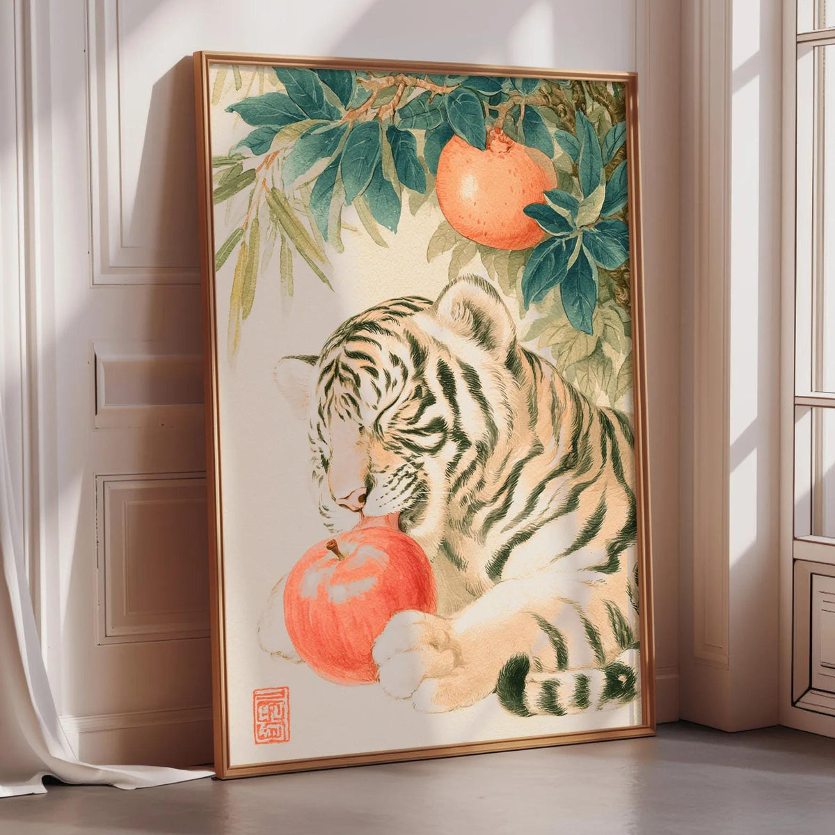 A framed painting depicting a tiger resting on a branch with an orange fruit, surrounded by green leaves.
