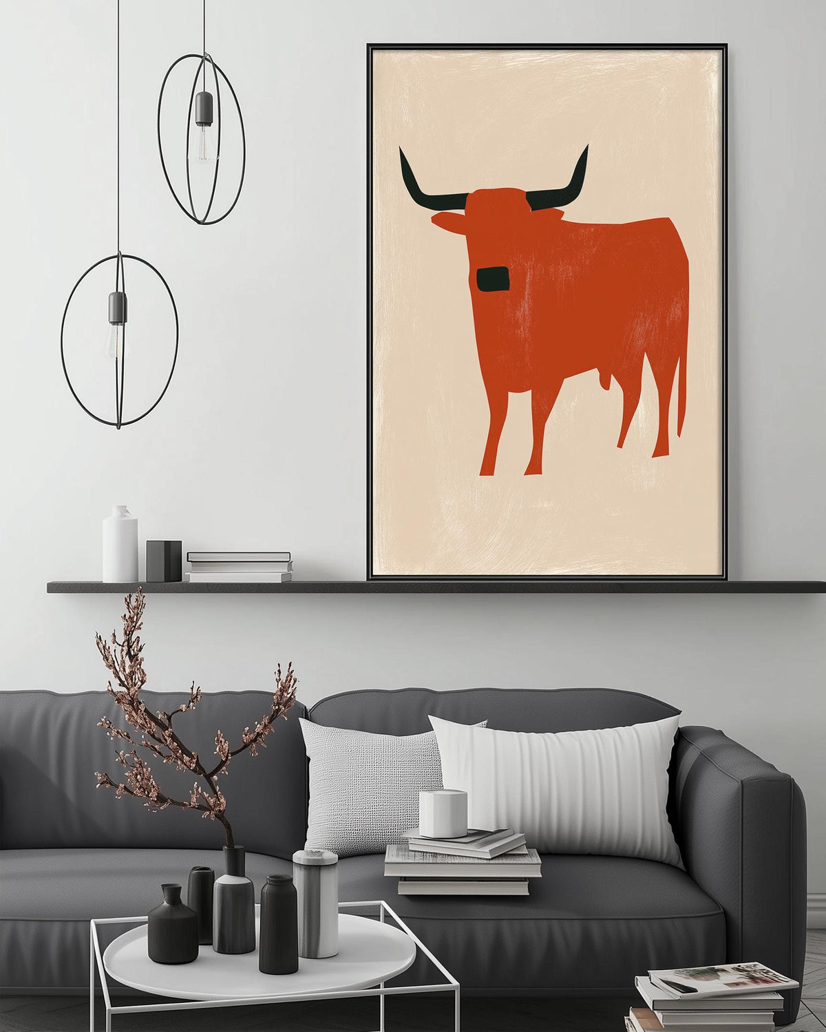 a modern living room with a gray sofa, a coffee table, and a large abstract painting of a bull on the wall.