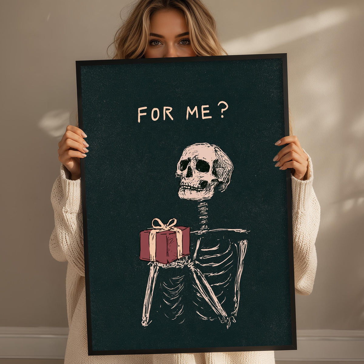 A woman holding a framed poster with a skeleton holding a gift.