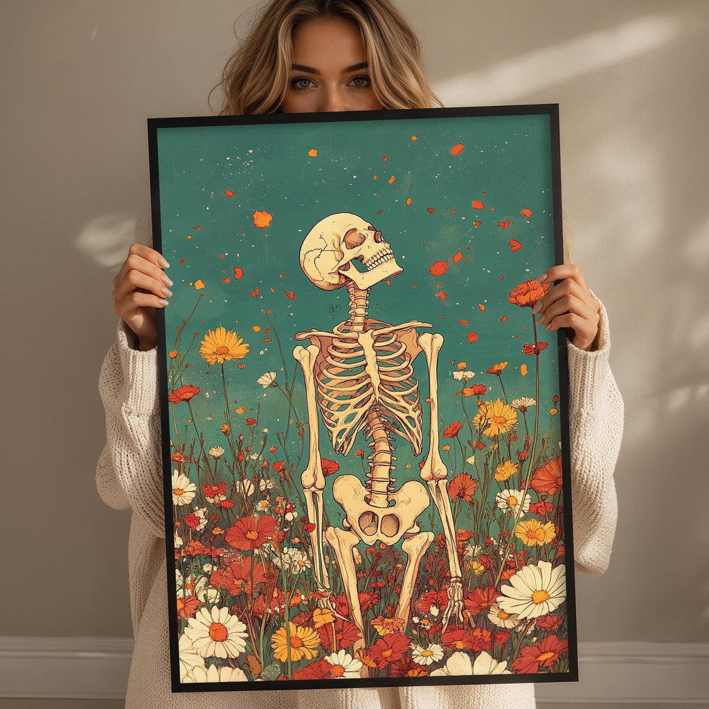A woman holding a framed artwork depicting a skeleton standing in a field of flowers.