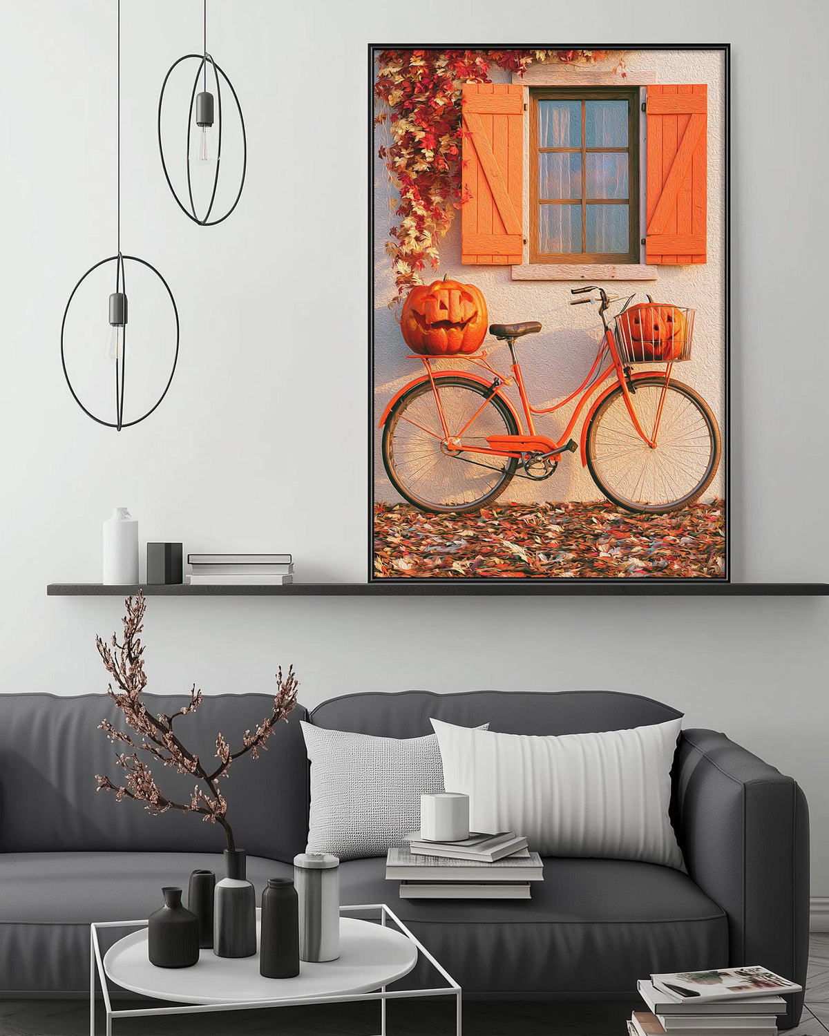 a cozy living room with a gray sofa, a coffee table, and a large framed picture of a bicycle with a pumpkin on the back. The picture is hanging on the wall above the sofa, creating a festive atmosphere.
