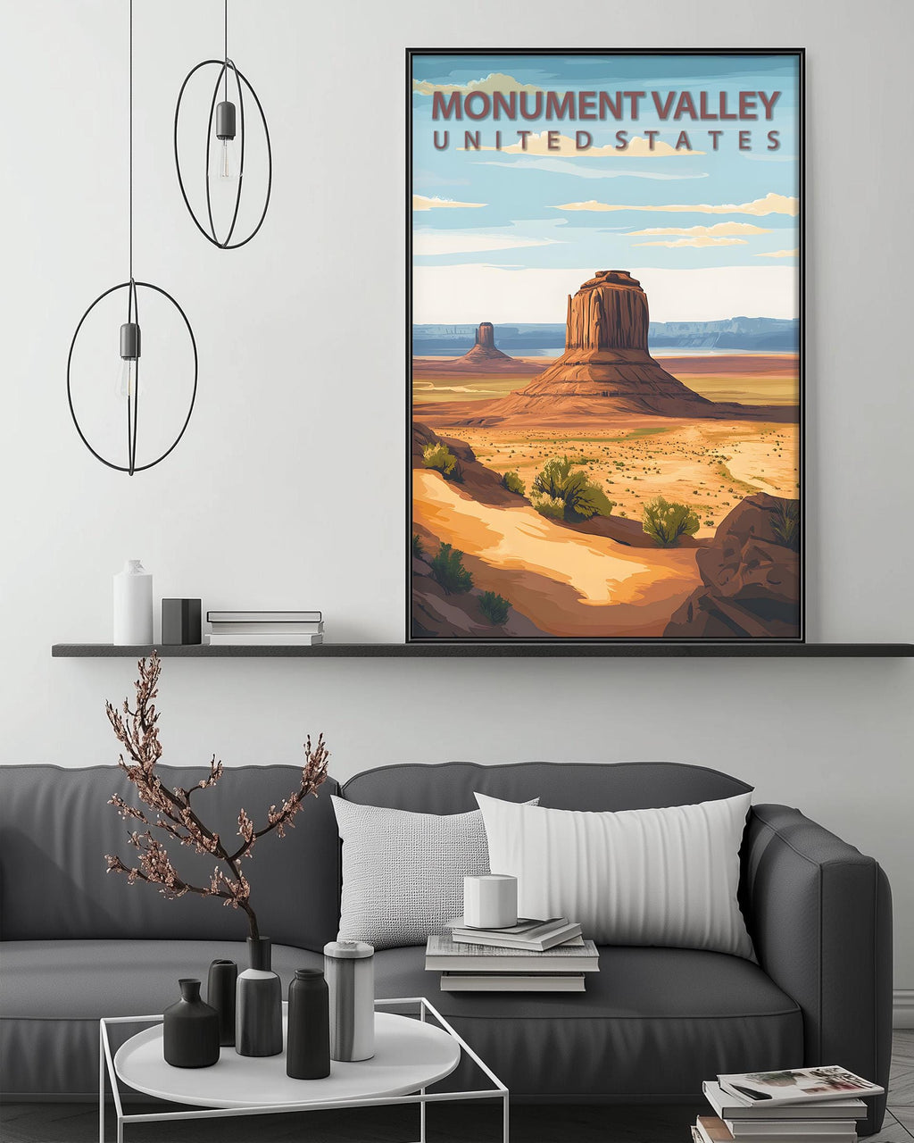 a large framed poster of Monument Valley, a famous landmark in the United States, hanging on a wall above a gray couch in a living room setting.
