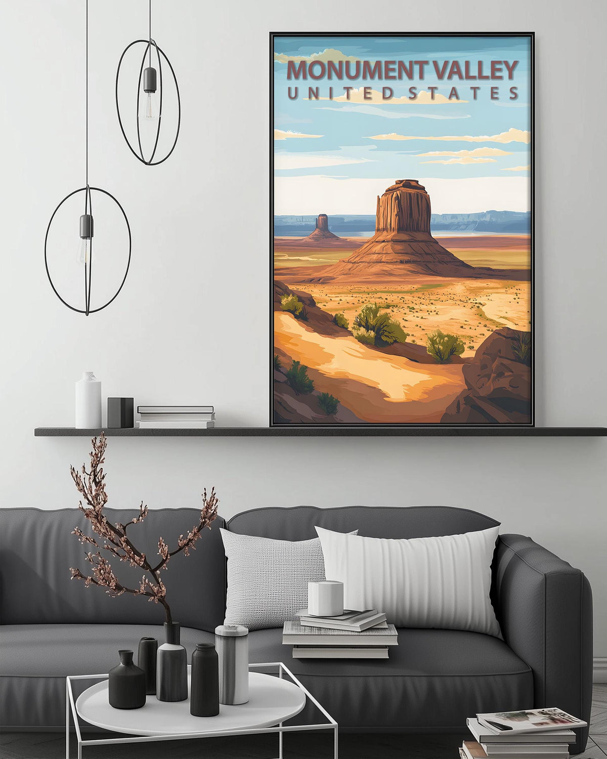 a large framed poster of Monument Valley, a famous landmark in the United States, hanging on a wall above a gray couch in a living room setting.