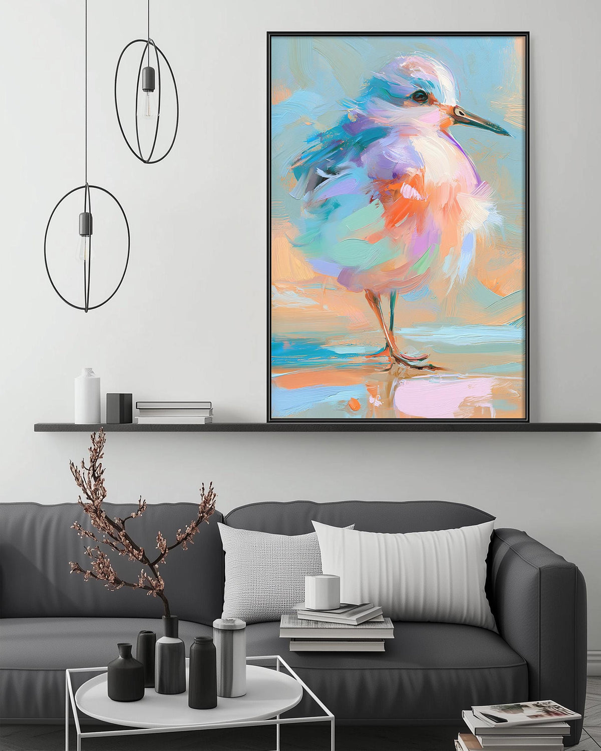 a large, colorful painting of a bird, which is hanging on a wall above a gray couch in a living room setting.