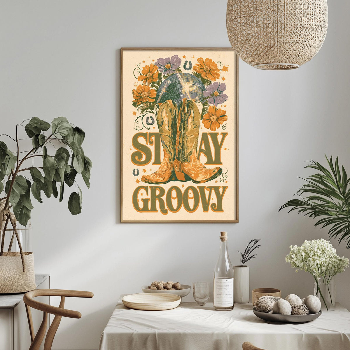 a framed poster with a cowboy boot and flowers, hanging on a wall above a dining table with various decorative items and plants.