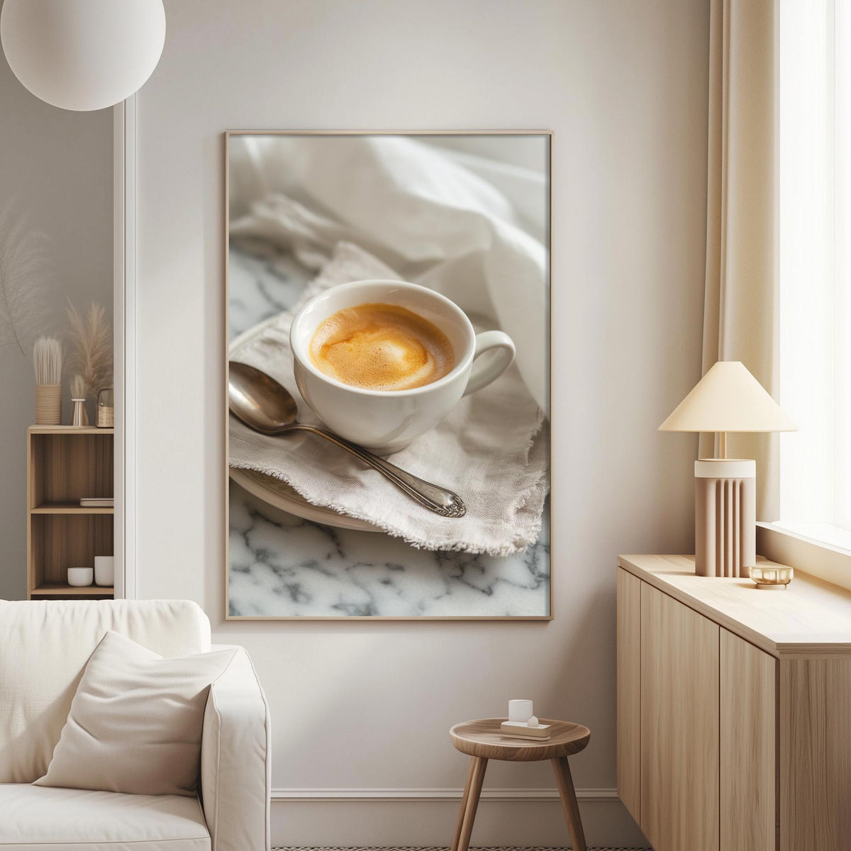 A framed photograph of a cup of coffee on a marble countertop, with a spoon resting on a napkin.