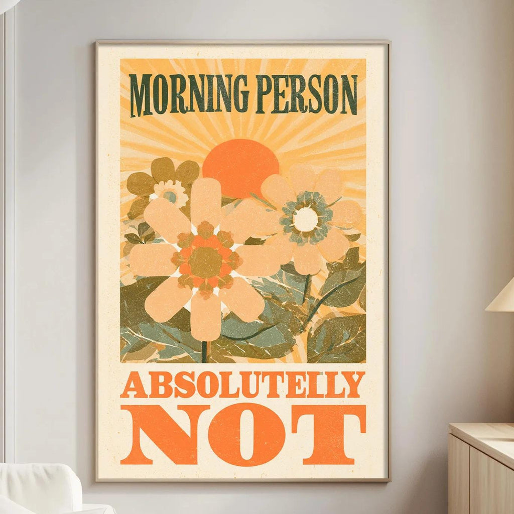 a poster with a floral design and the text "MORNING PERSON ABSOLUTELY NOT" displayed on a wall in a living room setting.