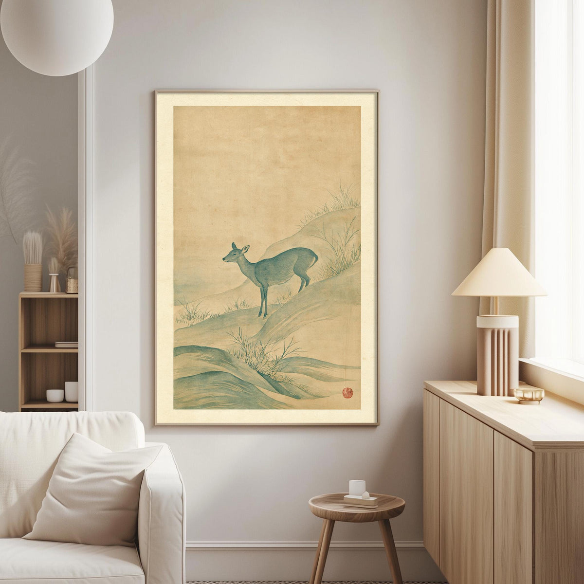 a living room with a large framed painting of a deer on the wall, a white sofa, a wooden side table, and a lamp on a wooden cabinet.