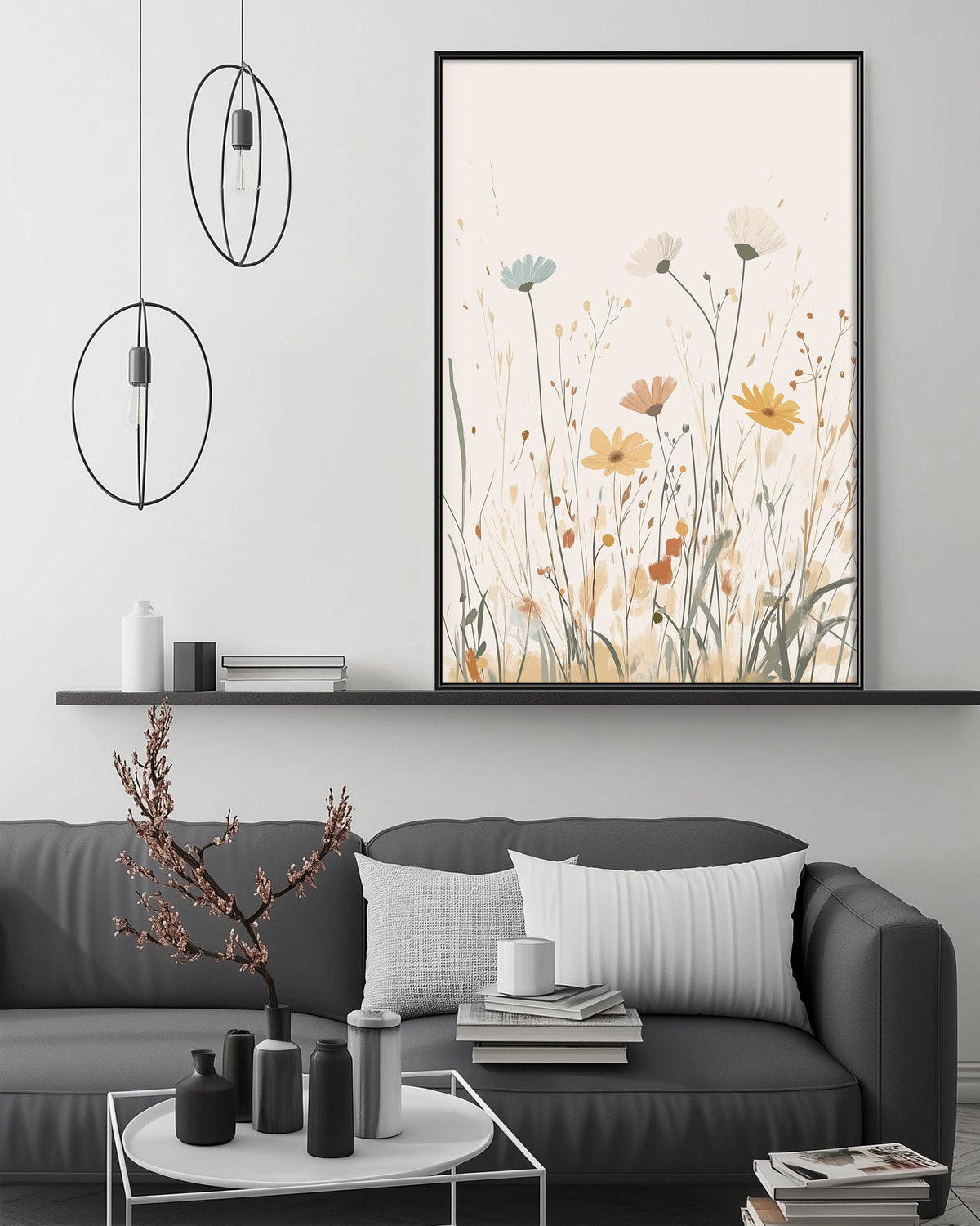 a modern living room with a gray sofa, a coffee table, and a large framed print of a floral design on the wall above the sofa.
