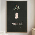a living room with a white couch, a wooden side table, and a framed poster on the wall. The poster has a ghost and the text "ANYONE?" written on it.