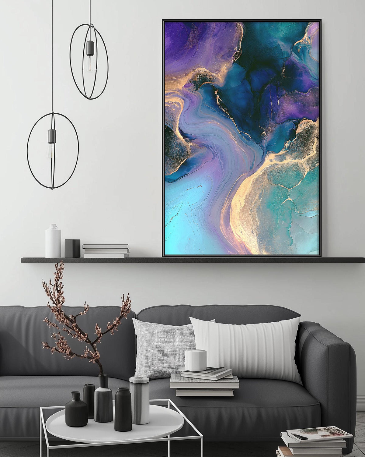 a modern living room with a gray sofa, a coffee table, and a large abstract painting hanging on the wall above the sofa.