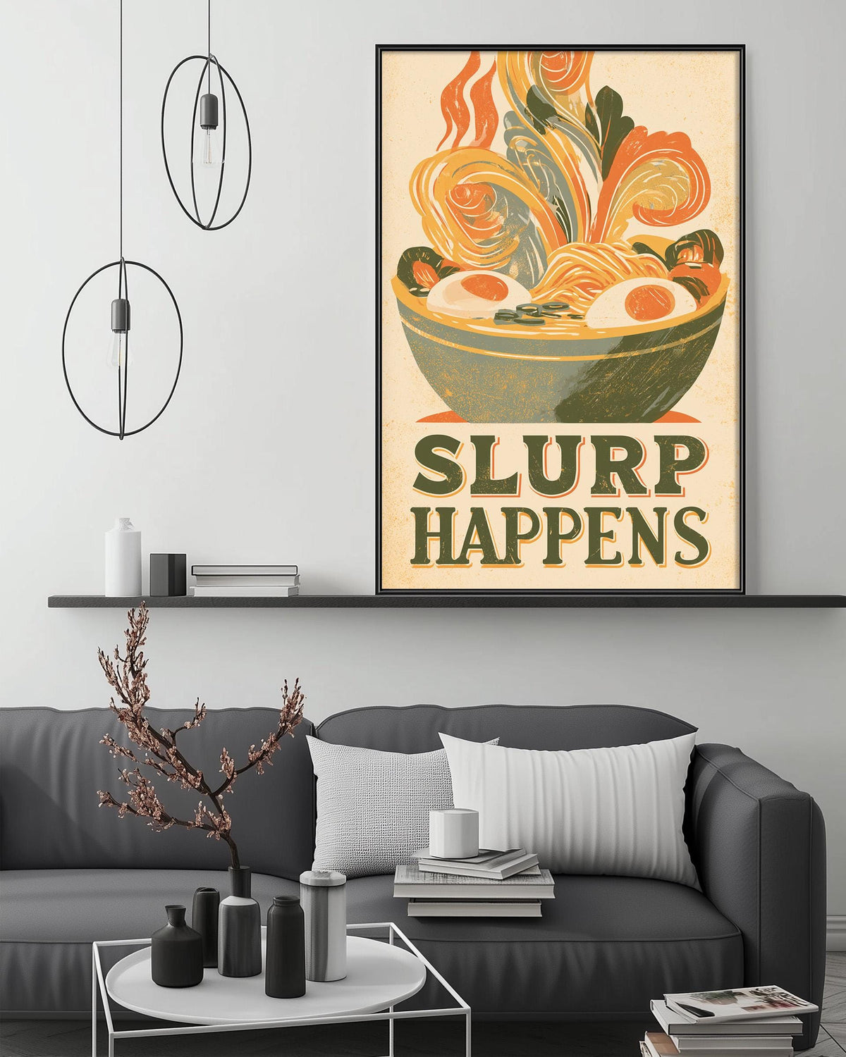 a cozy living room with a gray couch, a coffee table, and a framed poster of a bowl of noodles with the text "SLURP HAPPENS" displayed on the wall above the couch.