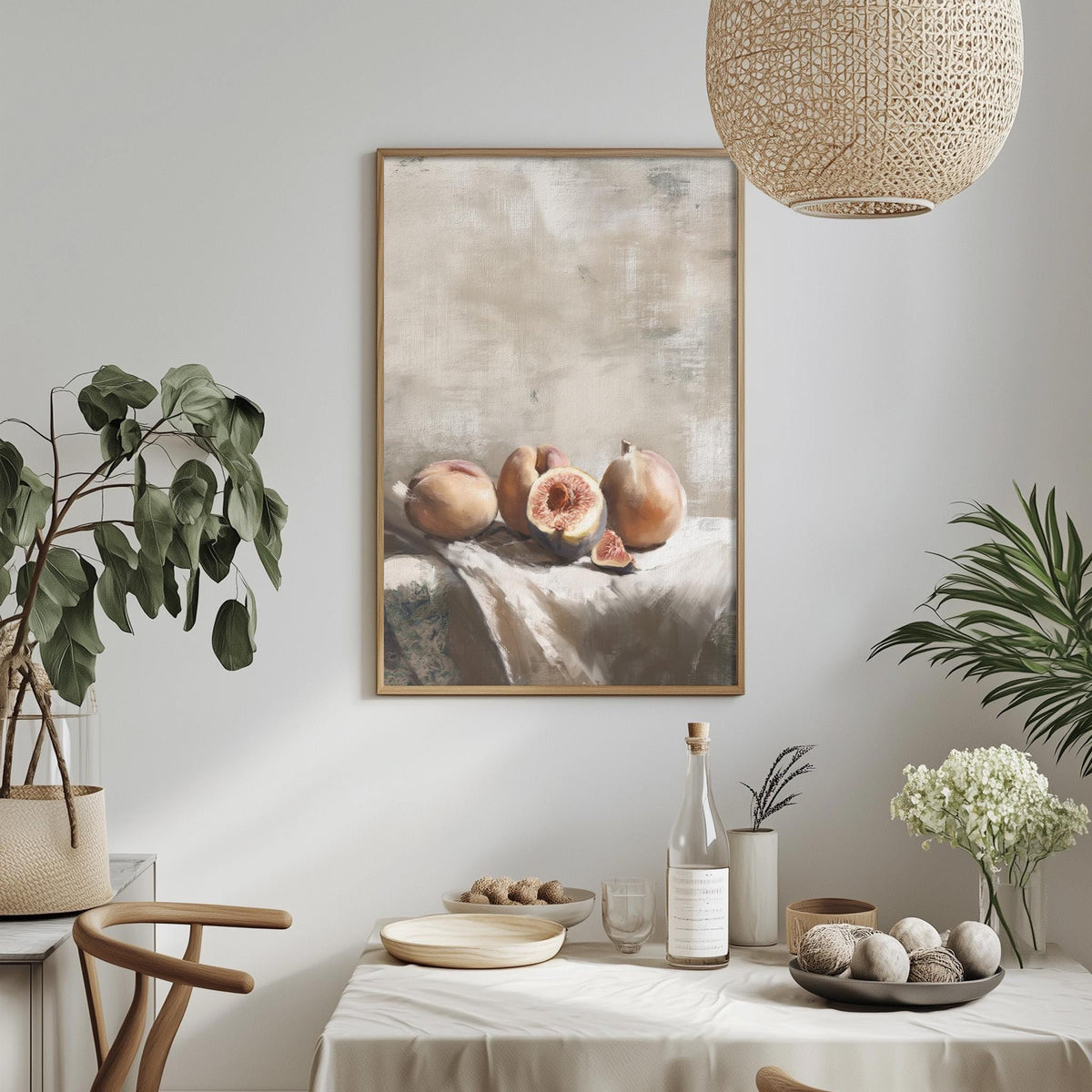 a dining table set with a white tablecloth, a bowl of fruit, a bottle, and a vase with flowers. A framed painting of fruit is hanging on the wall above the table.