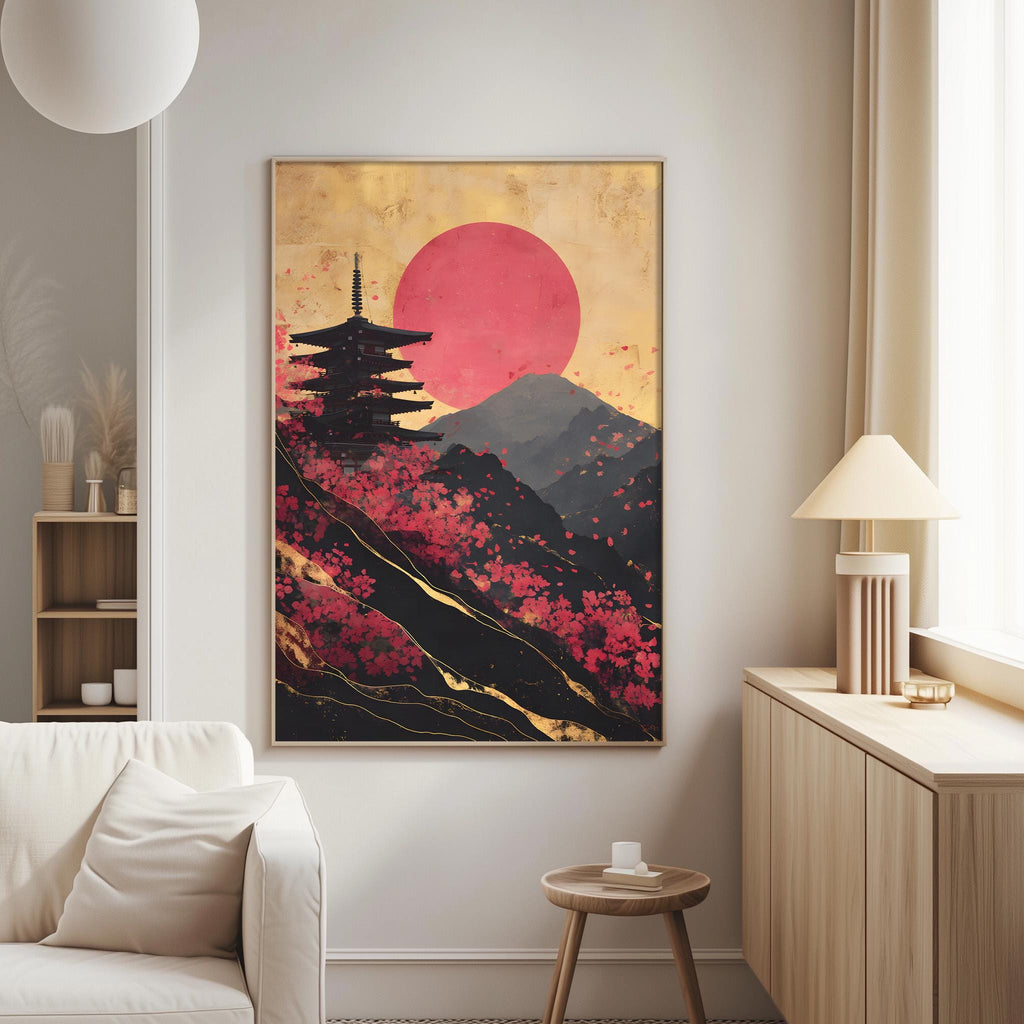 a large framed artwork depicting a pagoda on a mountain with a red sun in the background.